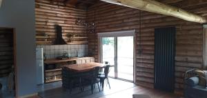 a kitchen with a wooden wall with a table and chairs at Ventanas al Norte in Chascomús