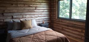a bedroom with a bed with a wooden wall at Ventanas al Norte in Chascomús +26 photos