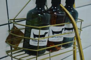 three bottles of wine in a wine rack at B&B Casa Ottavia Boutique Rooms in Mossa