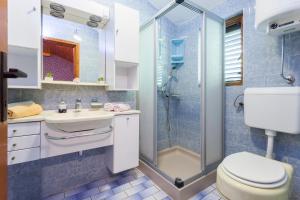 a bathroom with a shower and a toilet and a sink at Apartments Ante in Smokvica