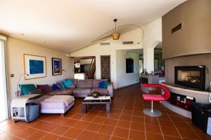 a living room with a couch and a fireplace at A Cala d Oro et plage privée pour 8 in Porto-Vecchio
