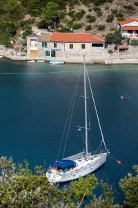 a sailboat sitting in the water near a house at House Linker in Kut