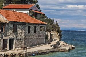 a building next to a body of water at House Linker in Kut