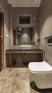 a bathroom with a white toilet and a sink at M S RESIDENCY in Chennai +41 photos