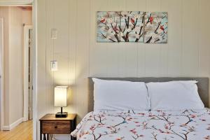 a bedroom with a bed with a bird painting on the wall at Powder Park Place- Upper Unit of Duplex - Great for Groups, Ski Rental Ticket Deals! in Killington