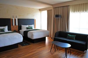 a hotel room with two beds and a couch at The Swiftwater in Swiftwater