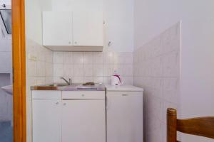 a small kitchen with a sink and a refrigerator at Apartments Diana in Dubrovnik +25 photos