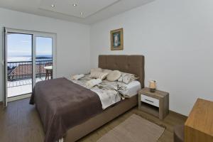 Postel nebo postele na pokoji v ubytování Apartments Nadi