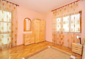 a living room with a dresser and a large window at House Zeljka in Podstrana
