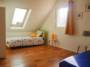 niewielka sypialnia z łóżkiem i 2 oknami w obiekcie Maison Neuve Confortable Proche Plages à Locmaria – Jardin, Terrasse, Wifi, Classée 3* - FR-1-418-209 w mieście Locmaria