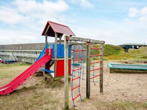 a playground with a slide in the sand at 4 person holiday home in Ringkøbing in Ringkøbing +21 photos