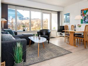 a living room with a couch and a table at 4 person holiday home in Ringkøbing in Ringkøbing
