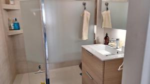 a small bathroom with a sink and a shower at Vaste appartement avec vue sur le port de plaisance in Arcachon +36 photos