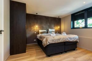 a bedroom with a bed with two stuffed animals on it at Welcome in - Luxe appartement in de hoofdstraat, met balkon en airco - Domburg in Domburg