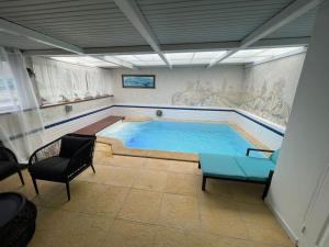 a large swimming pool in the middle of a room at Pool & Chill in Pierrefitte-sur-Seine +5 photos