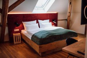 a bedroom with a large bed with a wooden headboard at Schmidtburger Hof in Weiler
