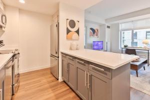 a kitchen with a refrigerator and a table at Luxury Apt Near Kendall Square in Cambridge