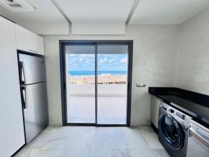 a laundry room with a view of the ocean at The beautiful view in Tangier