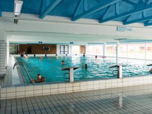 a large indoor swimming pool with people in it at 5 person holiday home on a holiday park in Lemvig in Lemvig +13 photos