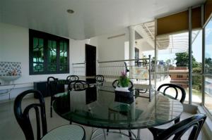 a dining room with a glass table and chairs at Munnar suncity in Munnar