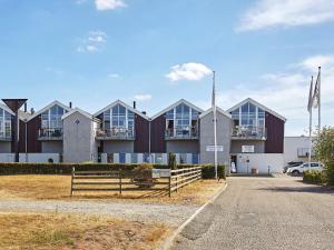 a building with a fence in front of it at 4 person holiday home in Glesborg in Glesborg