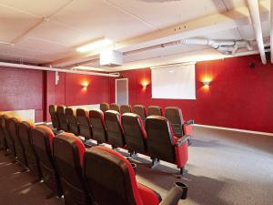 an empty room with red walls and chairs at 4 person holiday home in Glesborg in Glesborg +24 photos