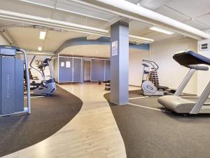 a gym with treadmills and ellipticals in a building at 4 person holiday home in Glesborg in Glesborg