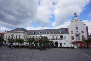 a large white building with a clock tower on it at FeWo Apland in Landau in der Pfalz