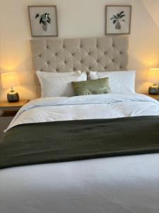 a bedroom with a large bed with a large headboard at 6 Smithhills - Sleeps 3 Central Excellent Transport Links Glasgow & Airport in Paisley