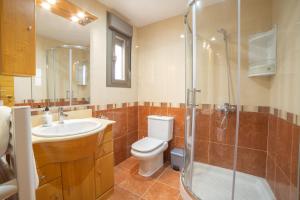 a bathroom with a toilet and a sink and a shower at Aranaz bardenas in Cadreita +14 photos