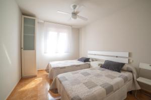a bedroom with two beds and a ceiling fan at Aranaz bardenas in Cadreita