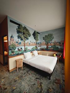a bedroom with a large bed with a painting on the wall at Hôtel Relais Monceau in Paris