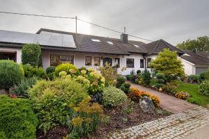 a house with a garden in front of it at Ferienwohnung Fernsicht in Zwiefalten