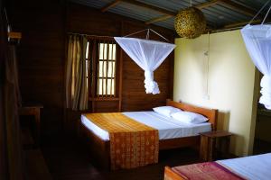 a bedroom with two beds and a window at Polwaththa Eco Lodges in Digana +57 photos