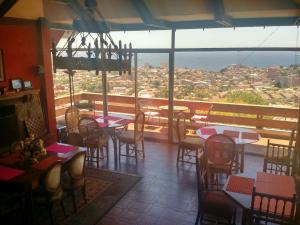 a restaurant with tables and chairs and a view of a city at My Father's House Bed in Viña del Mar