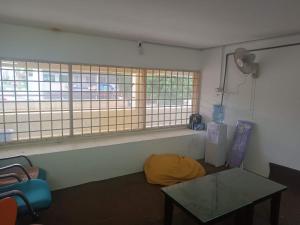 a living room with a table and a window at Jstay guesthouse in George Town +2 photos