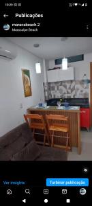 a living room with a kitchen and a kitchen island at Maraca Beach Residence 2 in Porto De Galinhas