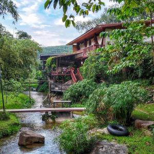 a house with a river in front of it at ห้องลานเคียงดาว บ้านสวนสราญชล in Ban Plai Nam (2)