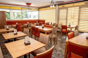 a restaurant dining room with wooden tables and chairs at Cristal Hotel in Eduardo Castex