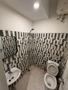 a bathroom with a toilet and a sink at Eisei House in Jakarta
