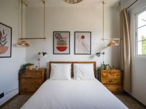 a bedroom with a bed and some pictures on the wall at Samar Retreat in Teror