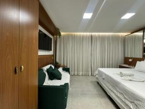 a hotel room with two beds and a tv at Île de Pipa com Hidromassagem in Pipa +15 photos