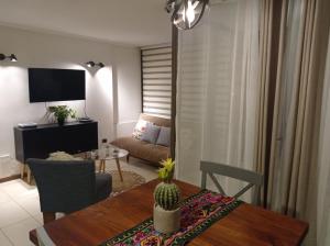 a living room with a table and a couch at Departamento sector Cavancha in Iquique +15 photos