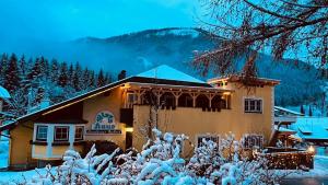 a building with snow on the side of it at Appartement Christina in Bad Kleinkirchheim