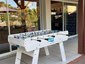 a foosball table sitting in front of a store at Chalet T3 Nature Piscine Tennis in Ondres