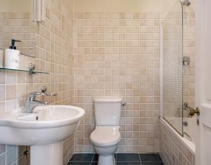 a bathroom with a toilet and a sink and a shower at 3 bedroom pet friendly home in the heart of Kenmare town in Kenmare +16 photos