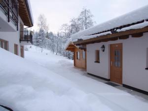 a snow covered yard next to a house at Ferienhaus Oberberg in Flachau