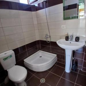 a bathroom with a toilet and a sink at Betty's Home in Korçë