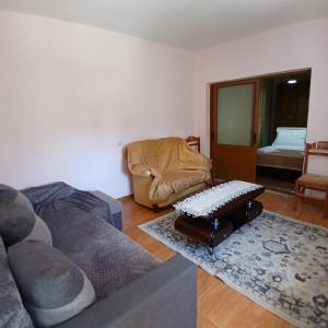 a living room with a couch and a chair at Betty's Home in Korçë