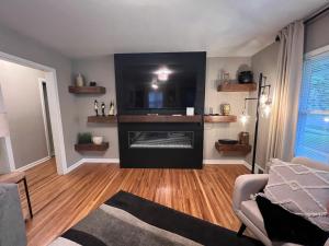a living room with a fireplace with a television at Main Attraction in Sioux Falls